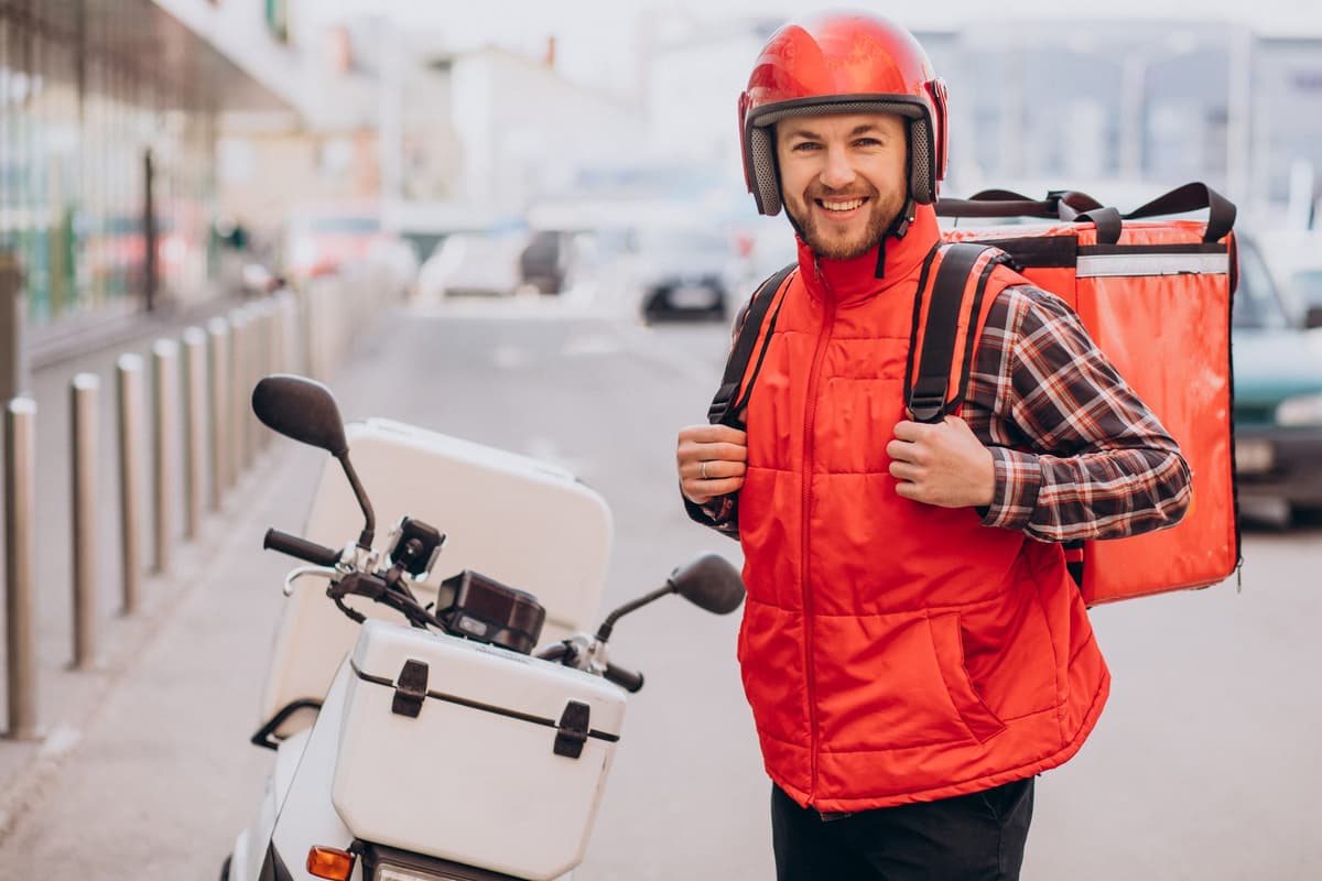 Smiling rider in a red jacket and helmet