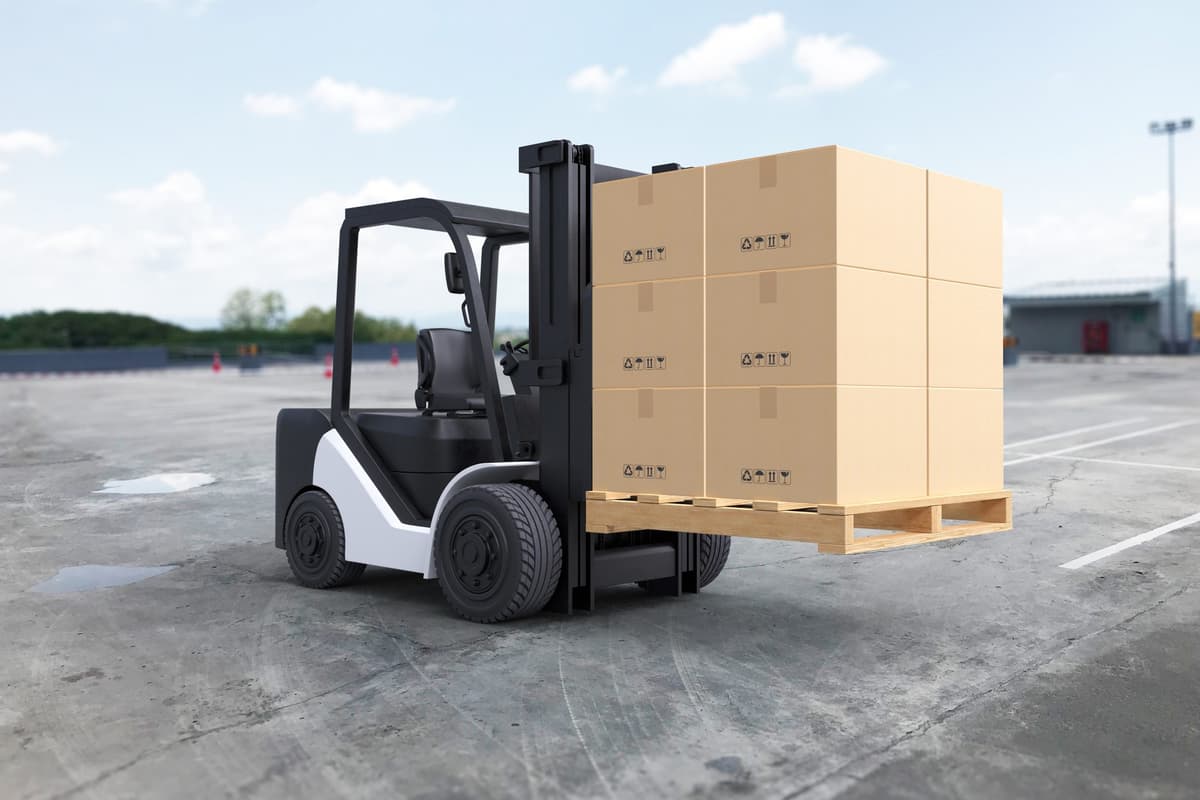 Forklift moving pallets of boxes in a warehouse